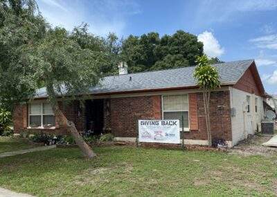Brick home exterior during a community 'Giving Back' roofing project