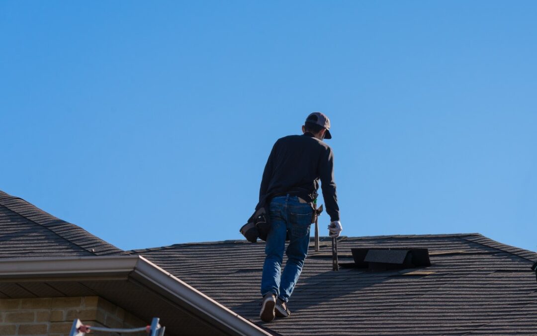 Worker walking on a damaged roof